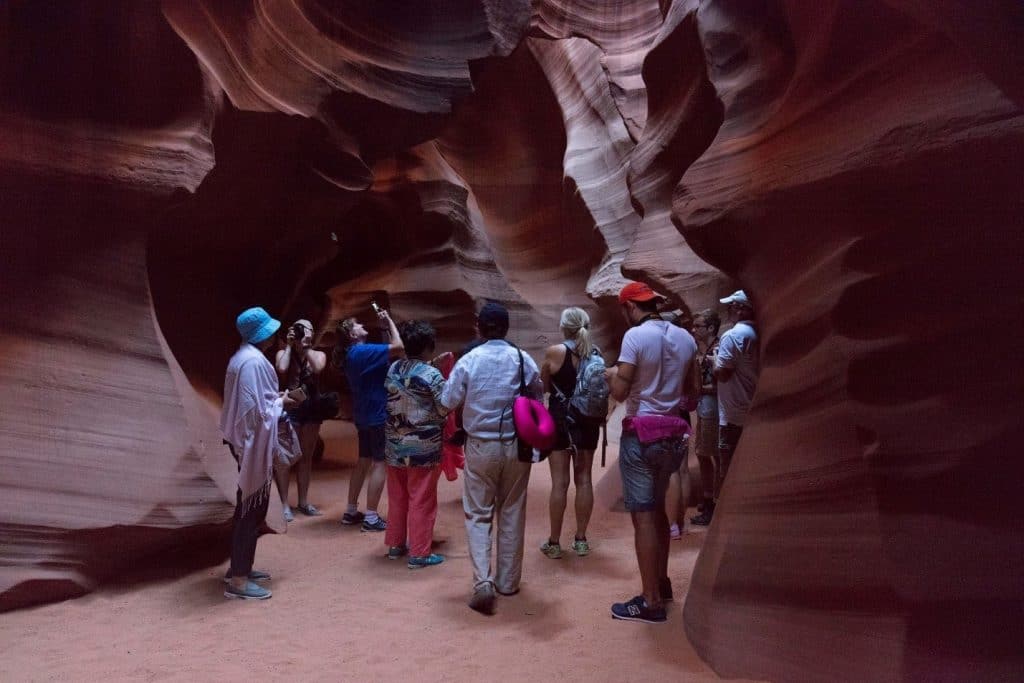 A group of people standing in a cave
Description automatically generated with medium confidence