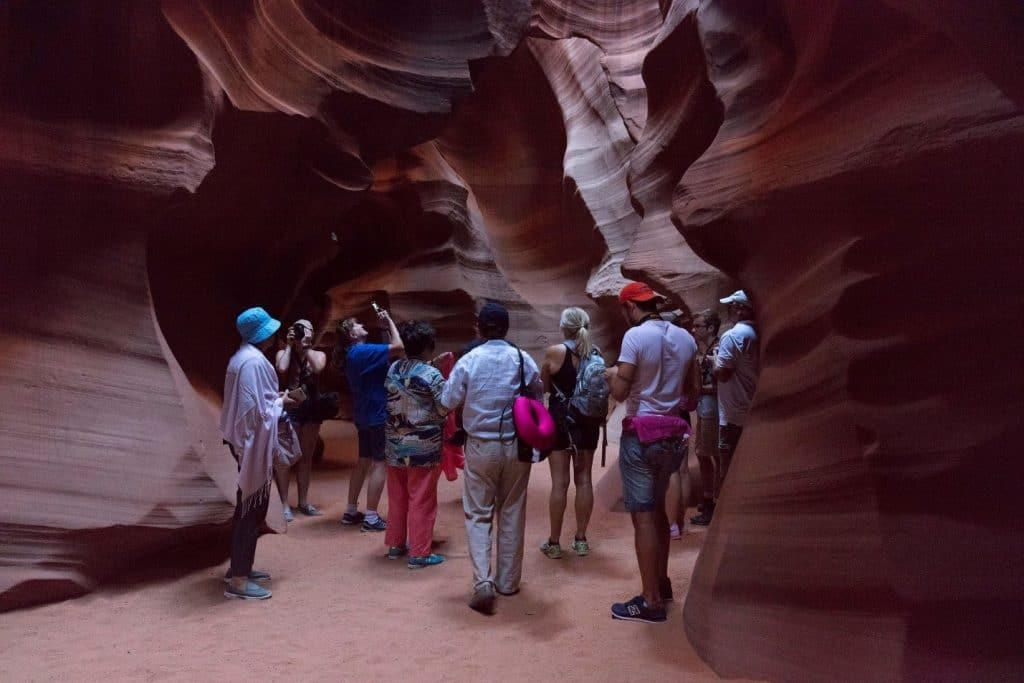 A group of people standing in a cave

Description automatically generated with medium confidence